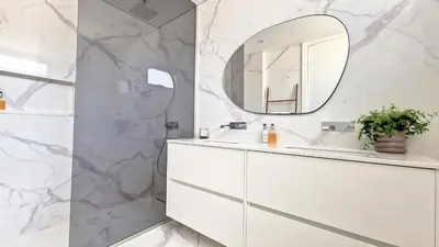 a bathroom with a white vanity and a mirror at Villa Obra-Prima by LovelyStay in Funchal