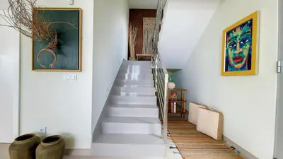 a staircase in a home with a painting on the wall at Villa Obra-Prima by LovelyStay in Funchal