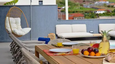 a table with a bowl of fruit on a patio at Villa Obra-Prima by LovelyStay in Funchal
