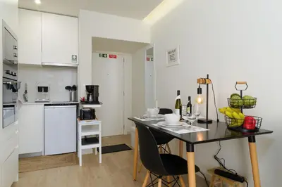 a kitchen and dining room with a table and chairs at Apartamentos do Mar - Pikis Flat in Funchal