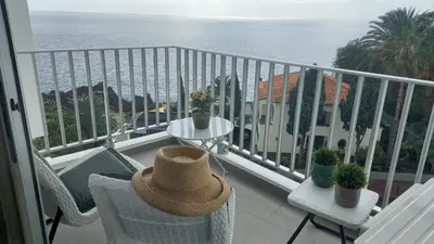 a balcony with a table and chairs and the ocean at Apartamentos do Mar - Pikis Flat in Funchal
