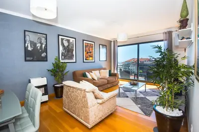 a living room with a couch and a table at Sunrise Apartment in Caniço