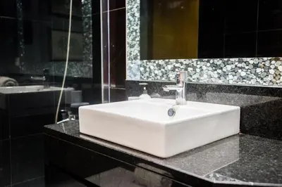 a bathroom with a white sink and a mirror at Sunrise Apartment in Caniço