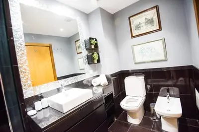 a bathroom with a toilet and a sink and a mirror at Sunrise Apartment in Caniço