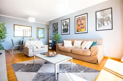 a living room with a couch and a table at Sunrise Apartment in Caniço