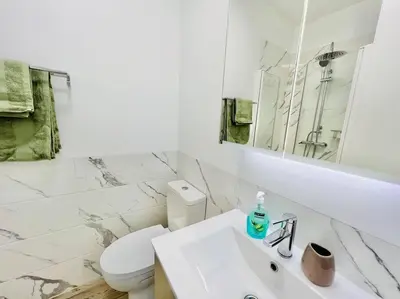 a white bathroom with a toilet and a sink at Haus am Meer by Your Madeira Rentals in Paul do Mar