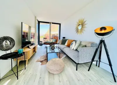 a living room with a couch and a tv at Haus am Meer by Your Madeira Rentals in Paul do Mar