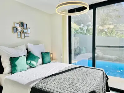 a bedroom with a bed and a large window at Haus am Meer by Your Madeira Rentals in Paul do Mar