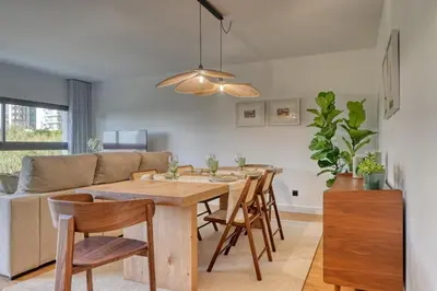 a dining room and living room with a table and chairs at São Lucas, a Home in Madeira in Funchal
