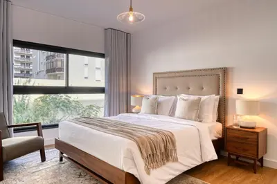 a bedroom with a large bed and a large window at São Lucas, a Home in Madeira in Funchal