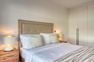 a bedroom with a large bed with white sheets and pillows at São Lucas, a Home in Madeira in Funchal