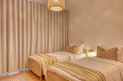 two beds sitting next to each other in a room at São Lucas, a Home in Madeira in Funchal
