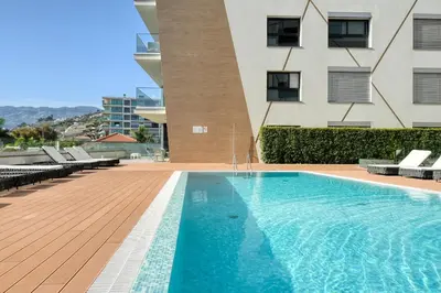 a swimming pool in front of a building at São Lucas, a Home in Madeira in Funchal