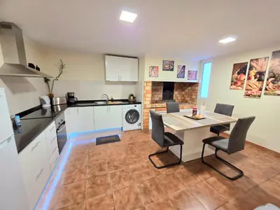 a kitchen with a table and chairs in a room at Near Levadas and Pico Ruivo, Santana Madeira Getaway with Terrace Views in Santana