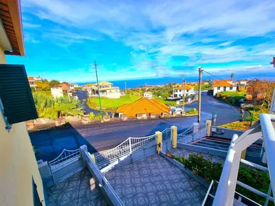 a view of a street from a balcony of a building at Near Levadas and Pico Ruivo, Santana Madeira Getaway with Terrace Views in Santana