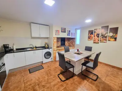 a kitchen and dining room with a table and chairs at Near Levadas and Pico Ruivo, Santana Madeira Getaway with Terrace Views in Santana