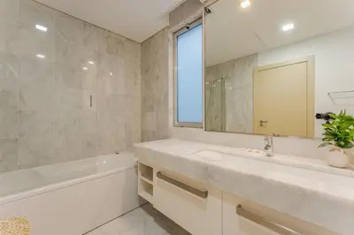 a bathroom with a sink and a tub and a mirror at FLH Madeira Palace Oceanfront Luxury in Funchal