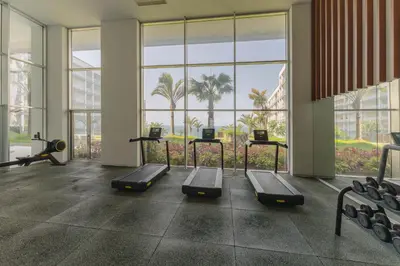a gym with treadmills and ellipticals in a building at FLH Madeira Palace Oceanfront Luxury in Funchal