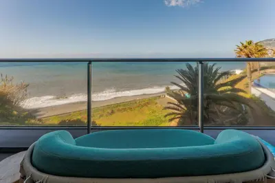 a room with a view of the beach at FLH Madeira Palace Oceanfront Luxury in Funchal