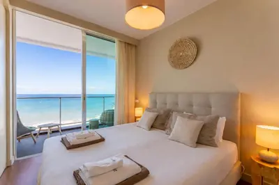 a bedroom with a bed with a view of the ocean at FLH Madeira Palace Oceanfront Luxury in Funchal