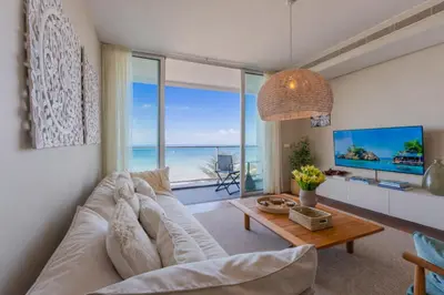 a living room with a large white couch and a table at FLH Madeira Palace Oceanfront Luxury in Funchal