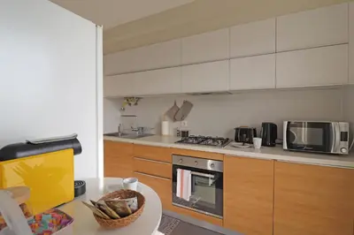 a kitchen with a stove and a microwave at Highrise Madalenas Apartment in Funchal
