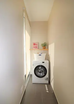 a washer and dryer in a hallway of a room at Highrise Madalenas Apartment in Funchal