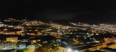 a view of a city lit up at night at Highrise Madalenas Apartment in Funchal