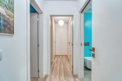 a hallway with a bathroom with a toilet and a tub at Vista Verde Apartment by Amazing Madeira in Funchal