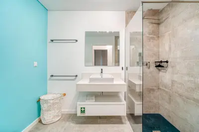 a white bathroom with a sink and a shower at Vista Verde Apartment by Amazing Madeira in Funchal
