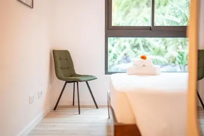 a room with a table and a chair and a window at Vista Verde Apartment by Amazing Madeira in Funchal