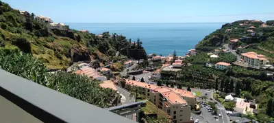 a view of a town on a hill with the ocean at Paradise Santo Amaro II in Ponta do Sol