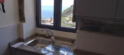 a kitchen sink with a view of the ocean at Paradise Santo Amaro II in Ponta do Sol