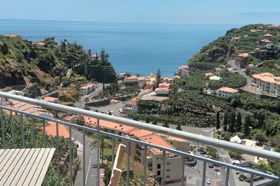 a view of a city with the ocean in the background at Paradise Santo Amaro in Ponta do Sol
