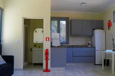 a kitchen with a red fire hydrant in a room at Paradise Santo Amaro in Ponta do Sol