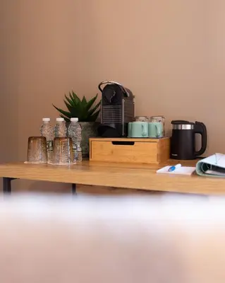 a shelf with a coffee maker and glasses on it at Casa do Mundo Madeira in Gaula