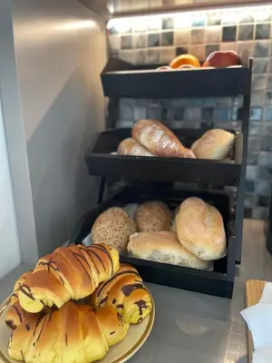 a bunch of different types of bread on a shelf at Casa do Mundo Madeira in Gaula