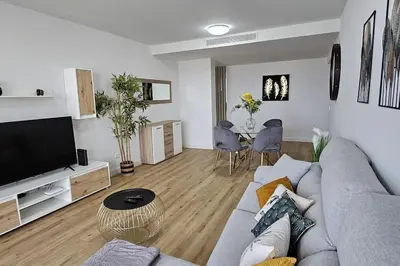 a living room with a couch and a television and a table at Vista Mar The Place by Rentallido in Funchal