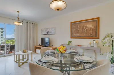 a living room with a glass table and chairs at Gilda Apartment by Atlantic Holiday in Funchal