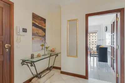 a hallway with a glass table and a mirror at Gilda Apartment by Atlantic Holiday in Funchal