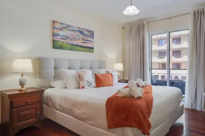 a bedroom with a large bed with two teddy bears on it at Gilda Apartment by Atlantic Holiday in Funchal