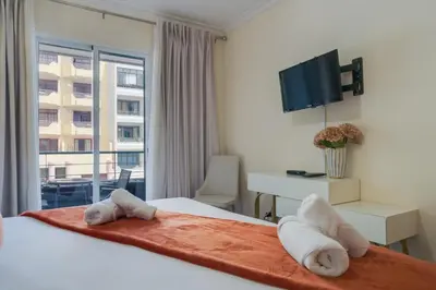 a hotel room with a bed with towels on it at Gilda Apartment by Atlantic Holiday in Funchal