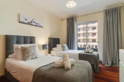 a hotel room with two beds and a window at Gilda Apartment by Atlantic Holiday in Funchal