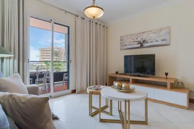 a living room with a television and a table at Gilda Apartment by Atlantic Holiday in Funchal