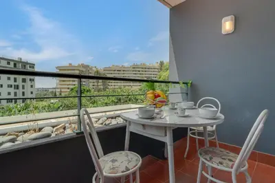 a small table and chairs on a balcony with a view at Gilda Apartment by Atlantic Holiday in Funchal