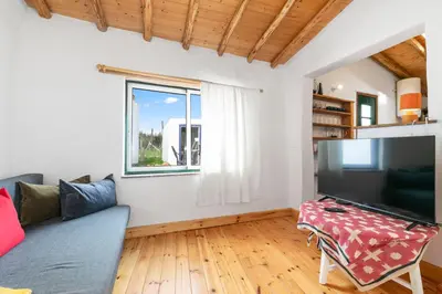 a living room with a couch and a large tv at Da Casa Sesta in Sagres