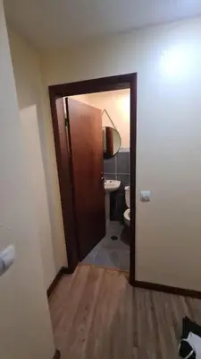 a bathroom with a door leading to a toilet at Tranquilidade em Mar e Montanha in Arco da Calheta