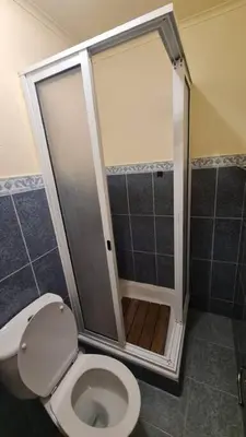 a bathroom with a toilet and a shower at Tranquilidade em Mar e Montanha in Arco da Calheta