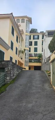an empty parking lot in front of a building at Apartamento São João in Funchal