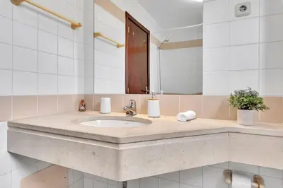 a bathroom with a sink and a mirror at Apartamento São João in Funchal
